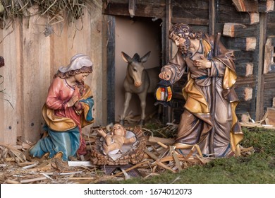 Christmas Nativity Scene - Jesus Christ, Mary And Joseph. Wooden Figurines, Donkey In The Background.