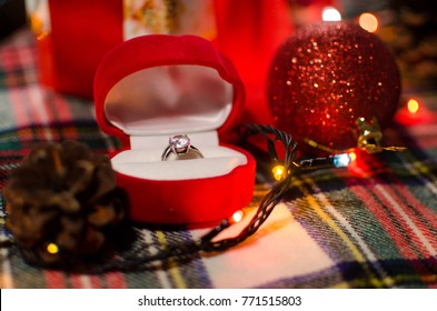 Christmas And New Year Background With Engagement Ring And Presents, Decorations For Christmas Tree. 