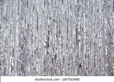 Christmas, New Year background and texture. Silver tinsel or shiny ribbons