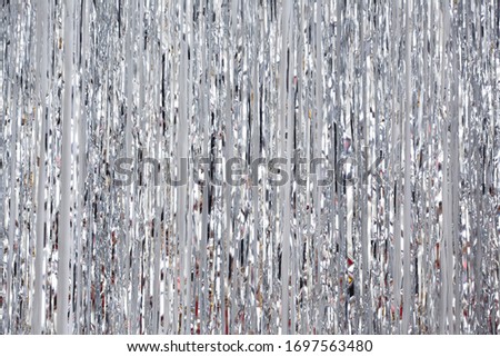 Christmas, New Year background and texture. Silver tinsel or shiny ribbons

