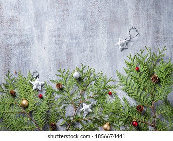 Christmas and New Year border design on the light wood background with thuja tree, and christmas toys. Top view and copy space - Shutterstock ID 1856674441
