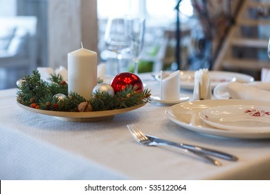 Christmas New Year Candle And Balls On A Table In A Restaurant 