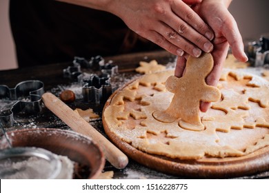 Christmas and New Year celebration traditions. Traditional festive food making, family culinary. Friends cutting cookies of raw gingerbread dough