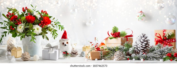 Christmas Or New Year Concept With Flower Arrangement, Gift Boxes And Christmas Decorations On Table. Festive Still Life.