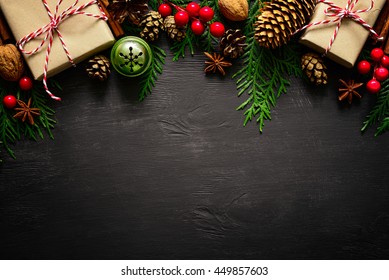 Christmas or New Year dark wooden background, Xmas black board framed with season decorations, space for a text, view from above