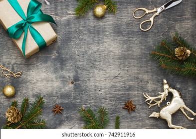 Christmas, New Year Dark Wooden Flat Lay Frame With A Gift And Deer. Winter Holiday Concept Composition. Copy Space