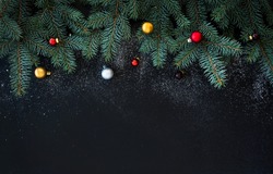 Christmas Or New Year Decoration Background: Fur-tree Branches, Colorful Glass Balls  On Black Grunge Background With Copy Space