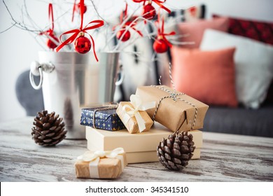 Christmas Or New Year Decoration On Modern Wooden Coffee Table. Cozy Sofa With Pillows On A Background. Living Room Interior And Holiday Home Decor Concept