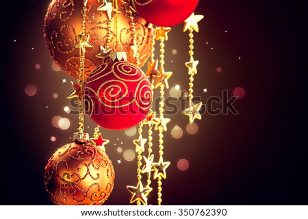 Christmas and New Year decorations border Design. Hanging Christmas Baubles and Garland over dark background
