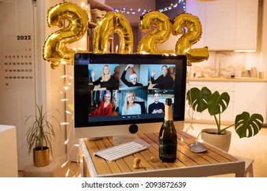 Christmas And New Year Eve Party 2022. Virtual Work Meeting In Video Call. Holiday Office Xmas At Home. Decorate Foil Balloons Of 2022 And Christmas Lights. Champagne Cheers For Celebrate