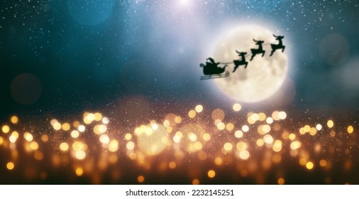 Christmas, New Year, festive garland lights on dark background. Santa Claus is flying on a sleigh pulled by reindeer on the background of a full moon. - Powered by Shutterstock