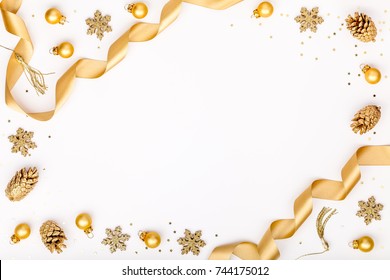 christmas or new year frame composition. christmas decorations in gold colors on white background with empty copy space for text. holiday and celebration concept for postcard or invitation. top view - Powered by Shutterstock