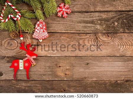 Christmas New Year holiday background. Greeting card with red gingerbread cookies, deer, candy cane and fir branch tree on old wooden table. Top view. Copy space
