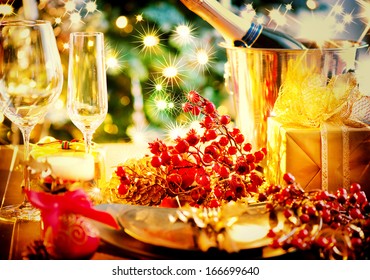Christmas And New Year Holiday Table Setting with Champagne. Celebration. Place setting for Christmas Dinner. Holiday Decorations. Decor. Served Table