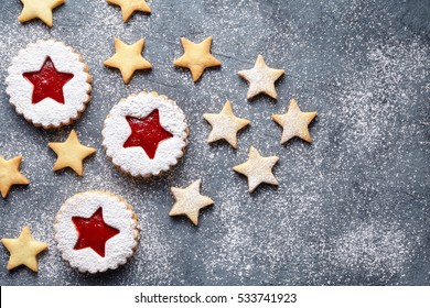 Christmas or New Year homemade cookies star with strawberry jam. Flat lay.Traditional Austrian christmas cookies - Linzer biscuits filled with red strawberry jam. Top view. Copy space.
