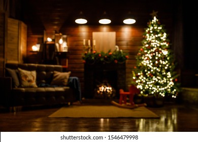 Christmas and New Year interior - blur background: fireplace, lamps, green Christmas tree, brown leather sofa, gifts, candles, moose rocking chair.  Lots of lights glowing in the dark. - Powered by Shutterstock