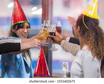 Christmas, New Year, office celebration party concept.  Business people toasting wine glasses with happiness.