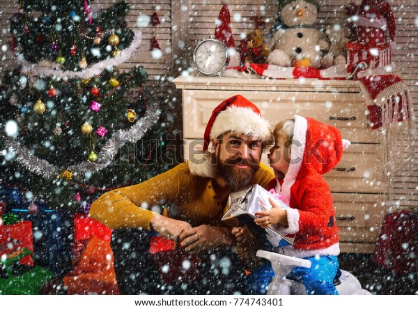 christmas new year snow concept Santa kid, bearded\
man at Christmas tree. Christmas happy child and father with\
present box. New year man and small boy on car. Xmas party\
celebration, fathers\
day.