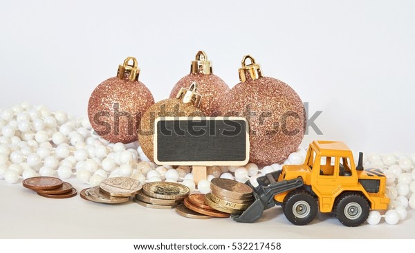 Christmas / New Year spend money\
concept. Money, ornaments, digger and sign on a white\
background.