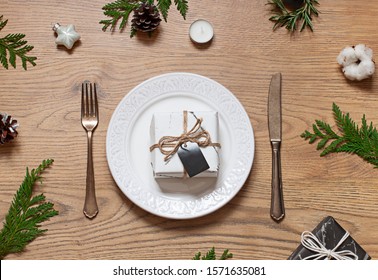 Christmas or New Year table settings on the wooden texture table with festive decoration. Top view - Shutterstock ID 1571635081