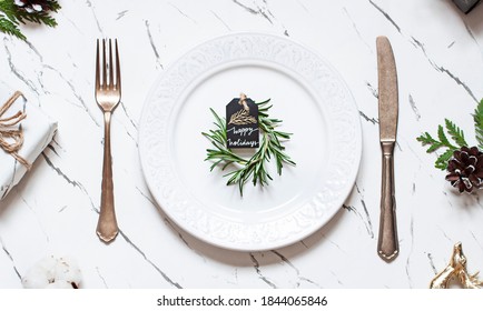 Christmas or New Year table settings on the marble texture table with festive decoration. Top view - Shutterstock ID 1844065846