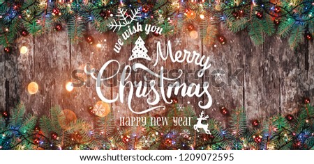 Christmas and New Year Typographical on wooden background with Fir branches. Xmas and Happy New Year theme. Flat lay, top view, copy space, wide composition