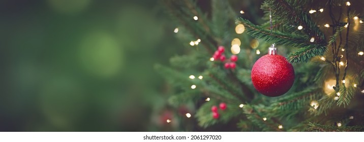 Christmas and New years eve Background. Beautiful Wide Angle Holiday Template with Christmas red ball on fir tree and highlights. Panoramic classic header Web banner with copy space for design.