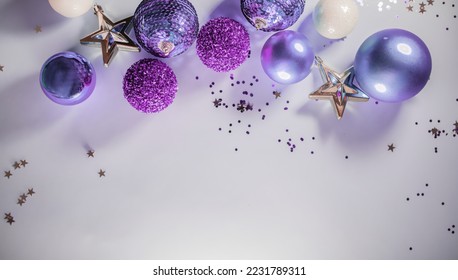 Christmas or New Year's flat lay composition of various decorative elements, sparkles and Christmas toys in purple tones on a lilac background. top view. copy space - Powered by Shutterstock