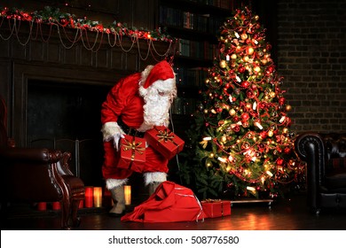 Christmas Night, Santa Claus Puts Gifts Under The Tree