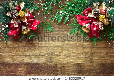 Christmas or Noel background with copy space for greeting text or other winter holidays information, flat lay composition of traditional X-mass decorations lying down wooden backdrop