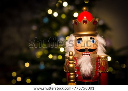 Christmas nutcracker with Christmas tree in background