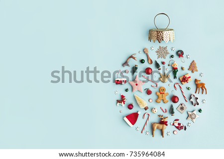 Christmas objects laid out in the shape of a Christmas bauble, overhead view