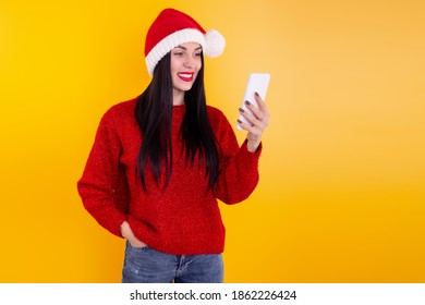 Christmas online congratulations. woman in Santa hat using mobile tablet for video call friends and parents