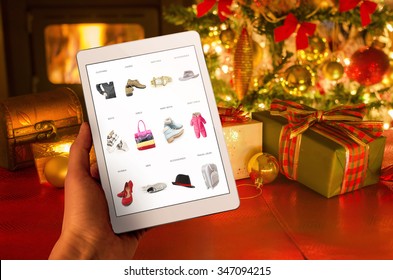 Christmas online shopping with tablet device. Christmas tree, gifts, lights and decorations.  - Powered by Shutterstock