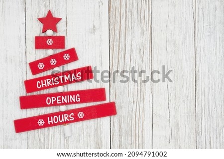 Christmas Opening Hours sign on red wood Christmas tree with weathered wood with space for your hours to be added