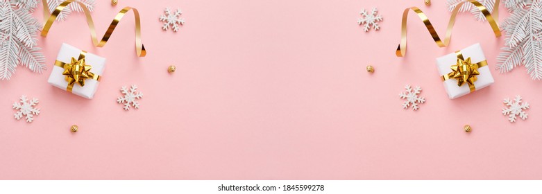 Christmas ornament with gold decorations on pastel pink background