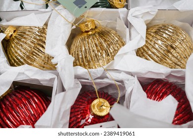 Christmas ornaments. Christmas market store - Gold and red decorations balls in boxes