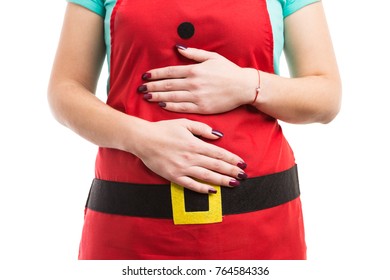 Christmas Overeating Or Indigestion Abdominal Pain Concept With Hands On Tummy And Red Holiday Apron