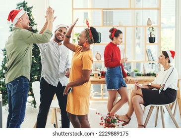 Christmas, party and high five with business people having fun in their office together during the festive season. Team, motivation and celebration with a man and woman colleague group at work - Powered by Shutterstock