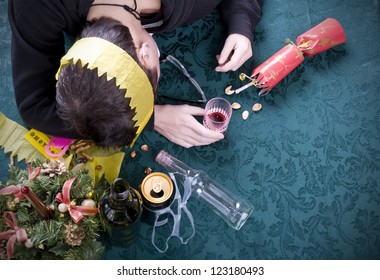 Christmas Party Morning After, Woman Asleep On Table With Alcohol At Christmas