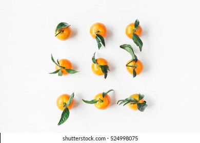 Christmas pattern. Christmas tangerines on white background. Flat lay, top view