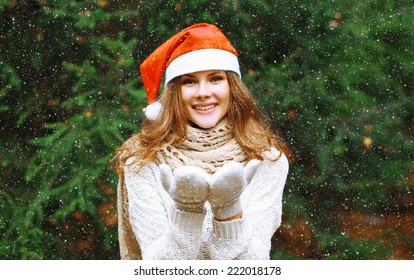 Christmas And People Concept - Happy Young Girl In Winter Hat Near Tree Having Fun Outdoors