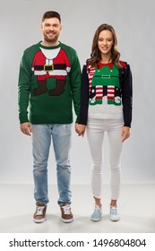 Christmas, People And Holidays Concept - Happy Couple At Ugly Sweater Party