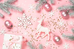 Christmas pink flat lay background with christmas present box and decorations on pink layout. Top view with copy space., a Holiday Photo by nadianb