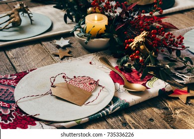 Christmas Place Setting, Name Card And Rustic Christmas Table With Ornaments And Flower Napkin On Wooden Table