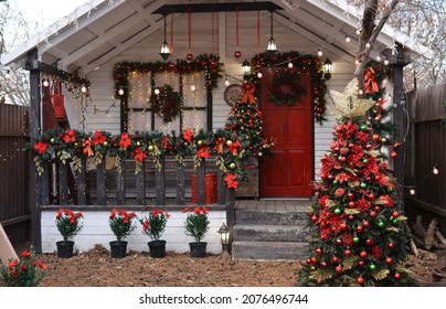 Christmas Porch Decorated With Glowing Garlands, Christmas Decorations,  Wreath On The Door,flowers,  Trees With Decorations. Decorations For Christmas And New Year.