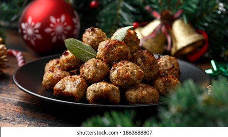 Christmas Pork stuffing meatballs with sage and onion. decoration, gifts, green tree branch on wooden rustic table