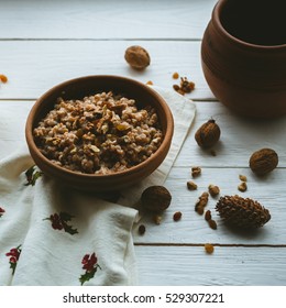 Christmas Porridge With Candles On White Wooden Background