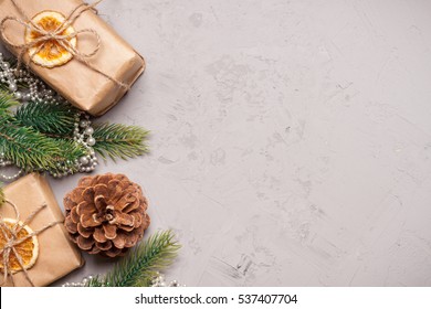 Christmas presents and tangerines on grey stone background