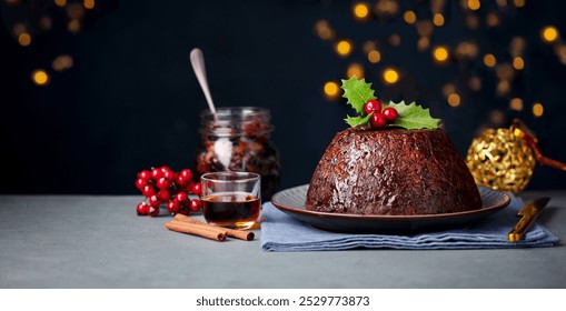 Christmas pudding, fruit cake. Traditional festive dessert. Dark background with lights garland. Copy space. - Powered by Shutterstock